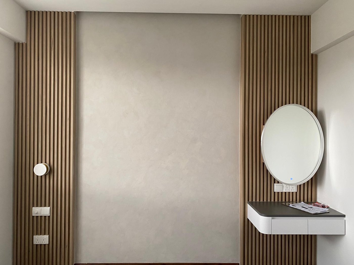 Soft limewash feature wall in a bedroom with timber slats