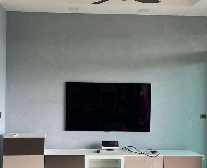Blue-grey textured feature wall behind a TV in a living room
