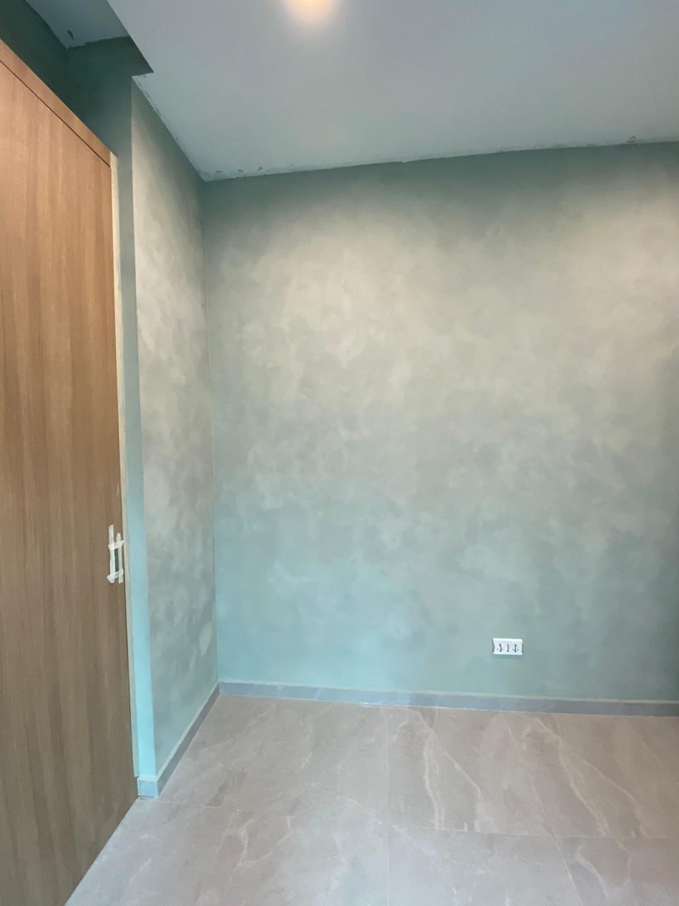 Soft sage-green limewash walls in a home