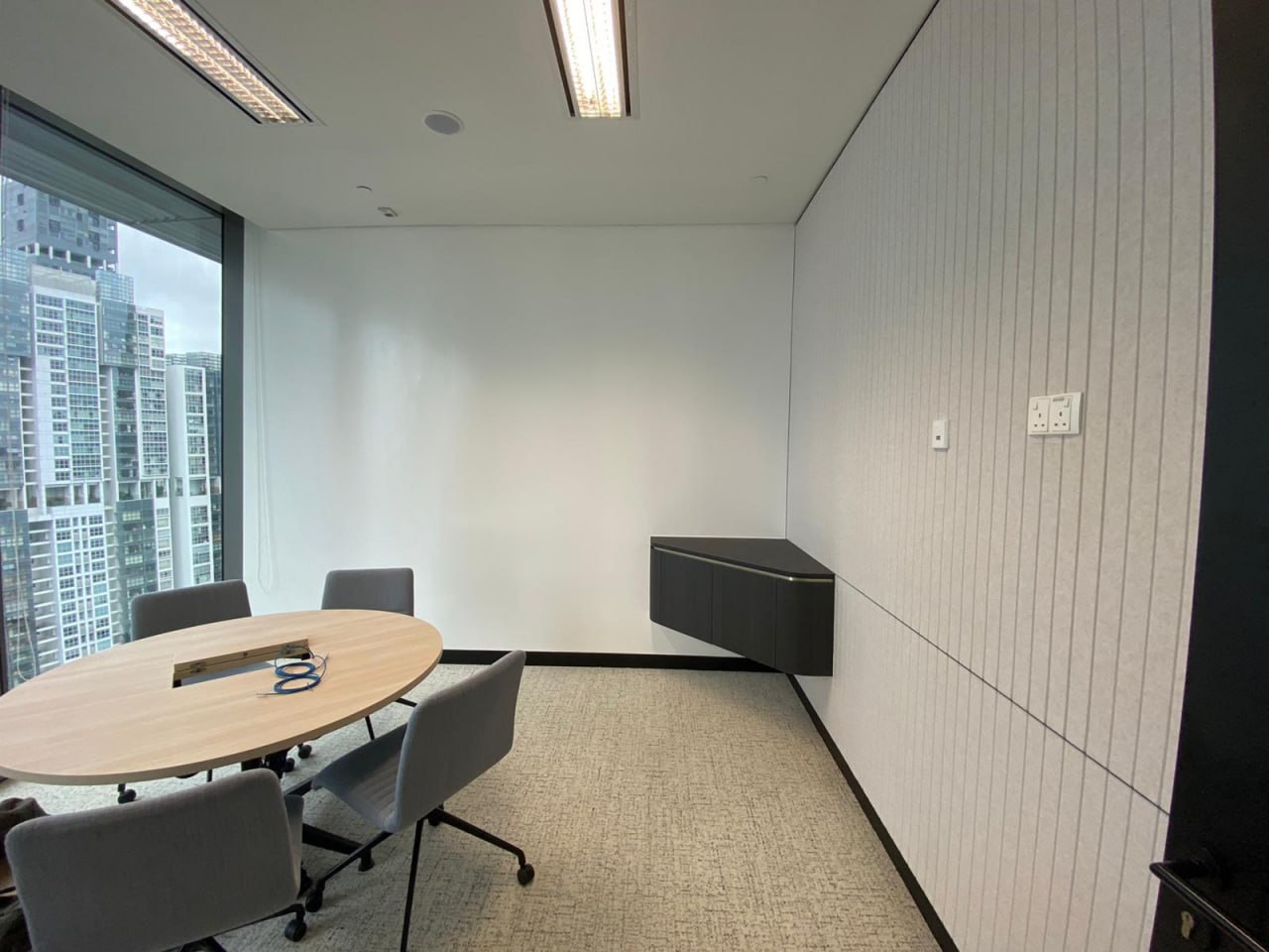 Meeting room with a full ZETA Whiteboard Paint wall beside the window and acoustic panels opposite, Guoco Tower