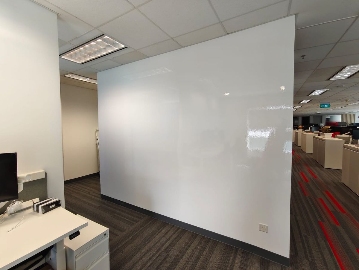 Full-height glossy whiteboard film wall in an open office